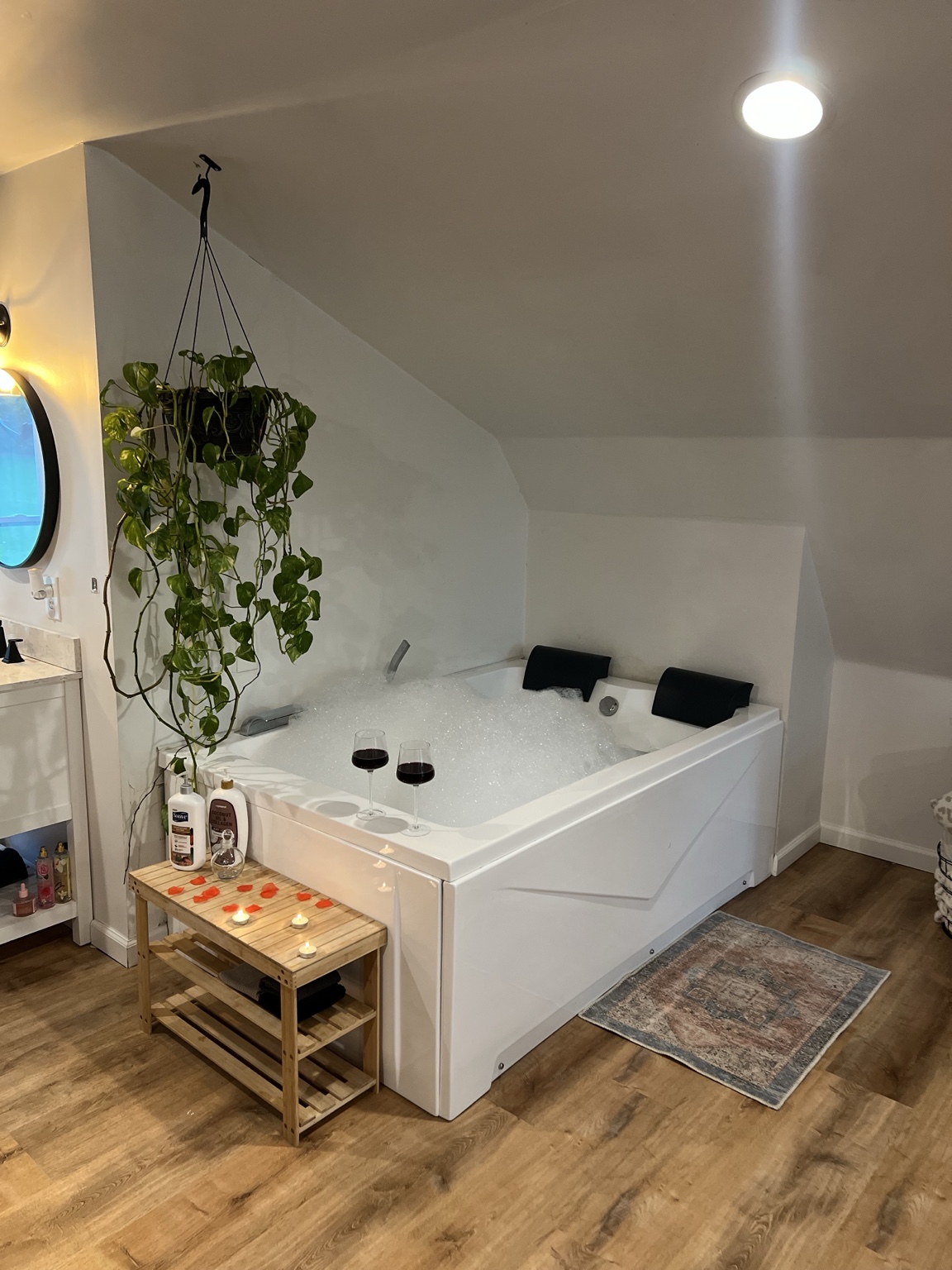 Wide view of the tub nook under the sloped loft ceiling