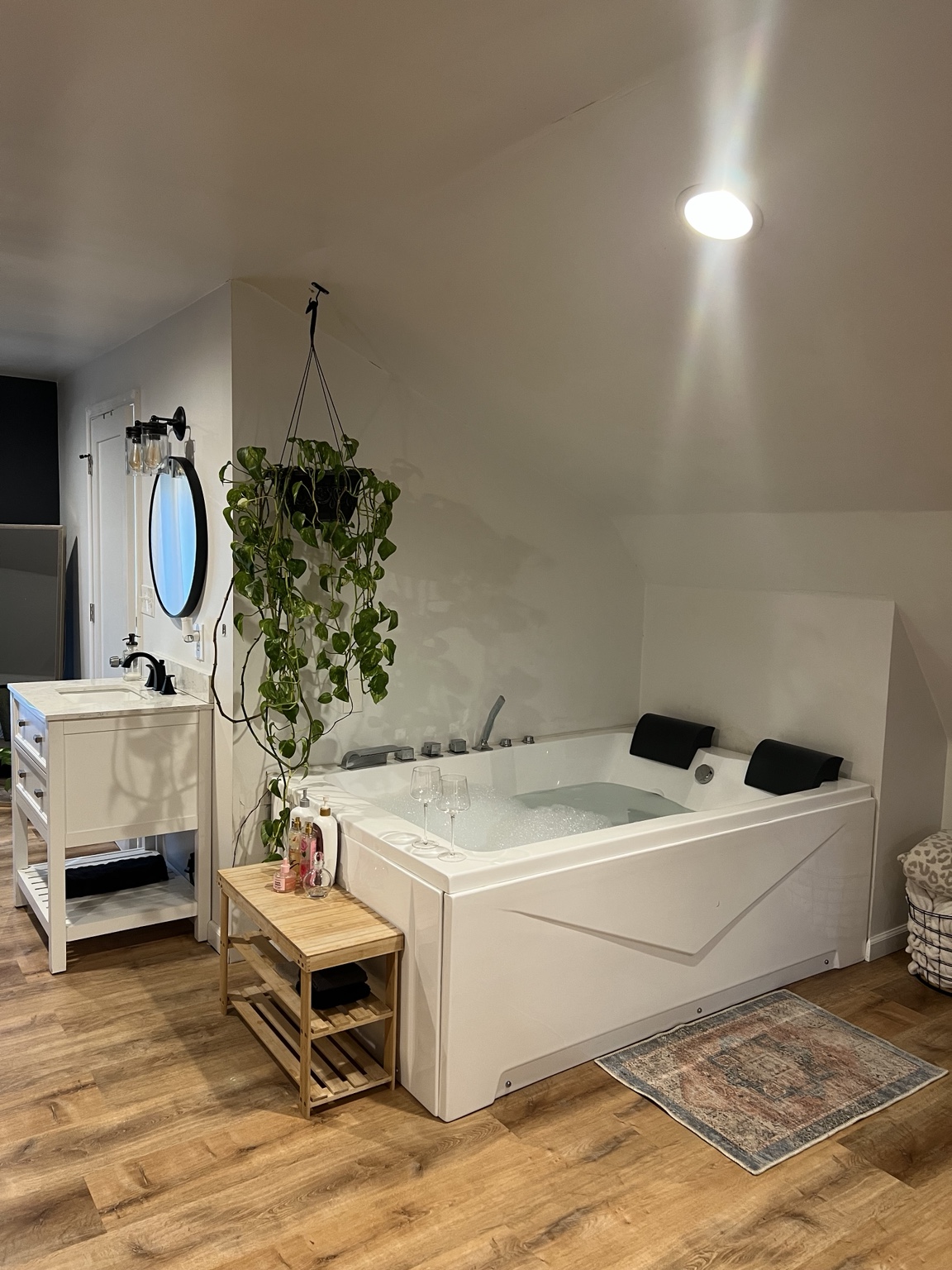 The two-person jetted tub drawn and waiting beside the vanity