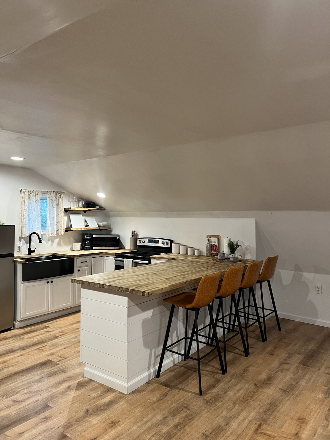 Kitchen bar seating beneath the sloped loft ceiling