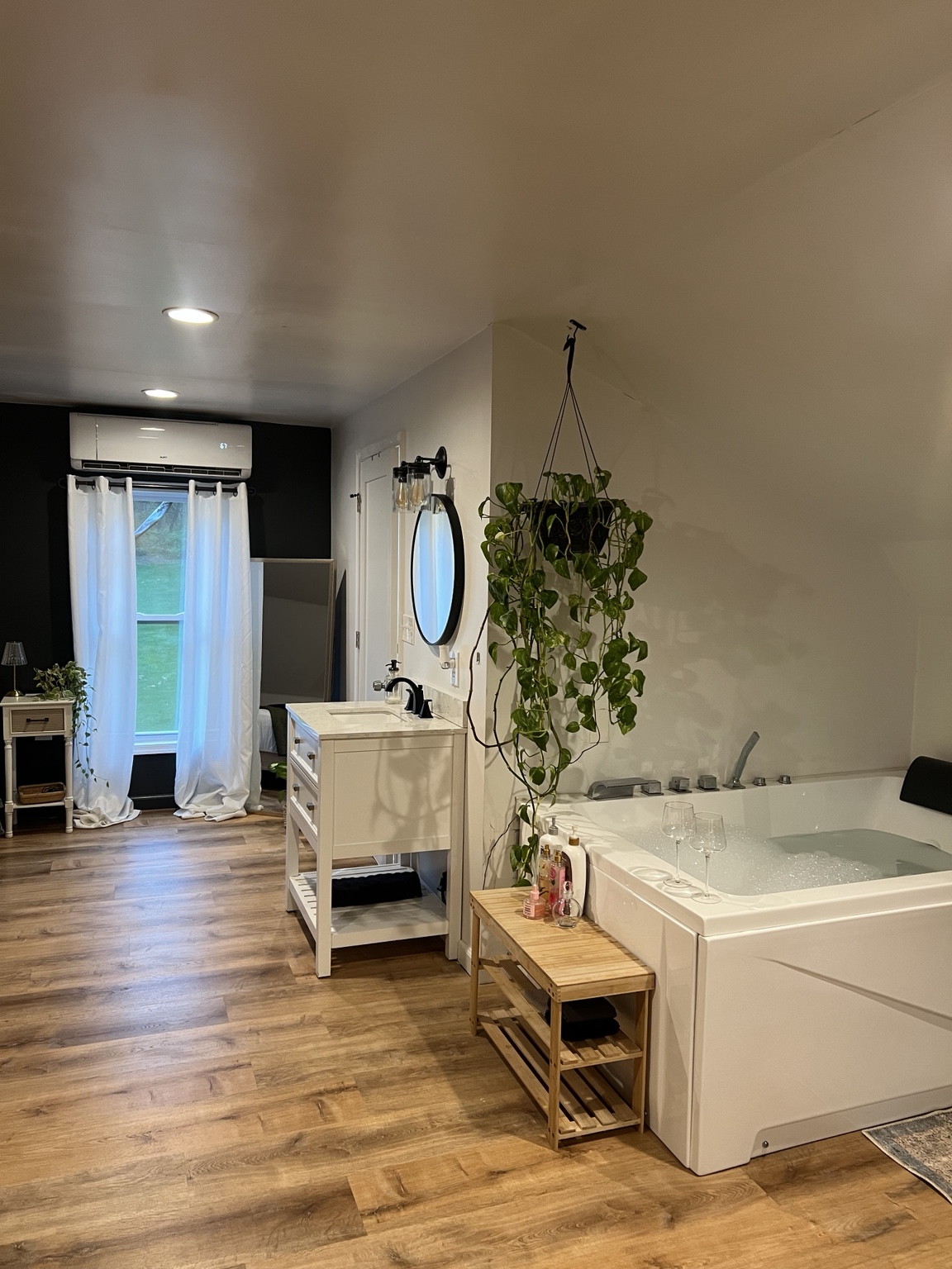 Tub and vanity with the sleeping area beyond