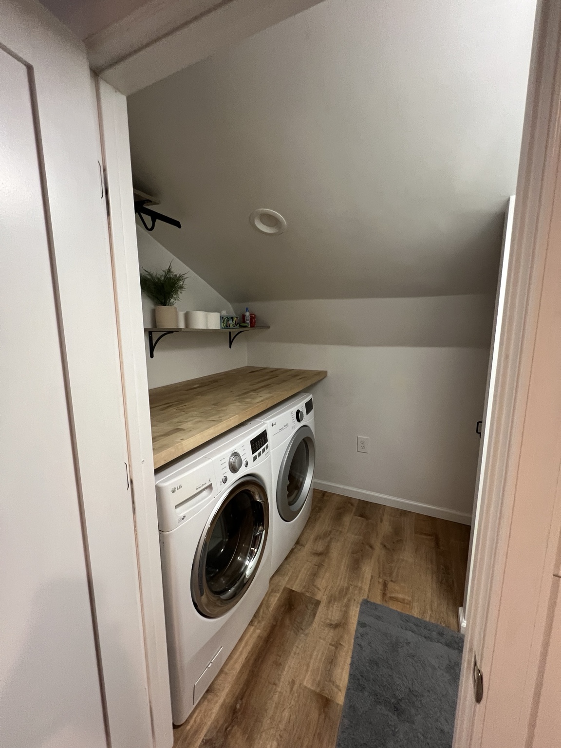In-suite laundry closet with washer, dryer and butcher-block counter