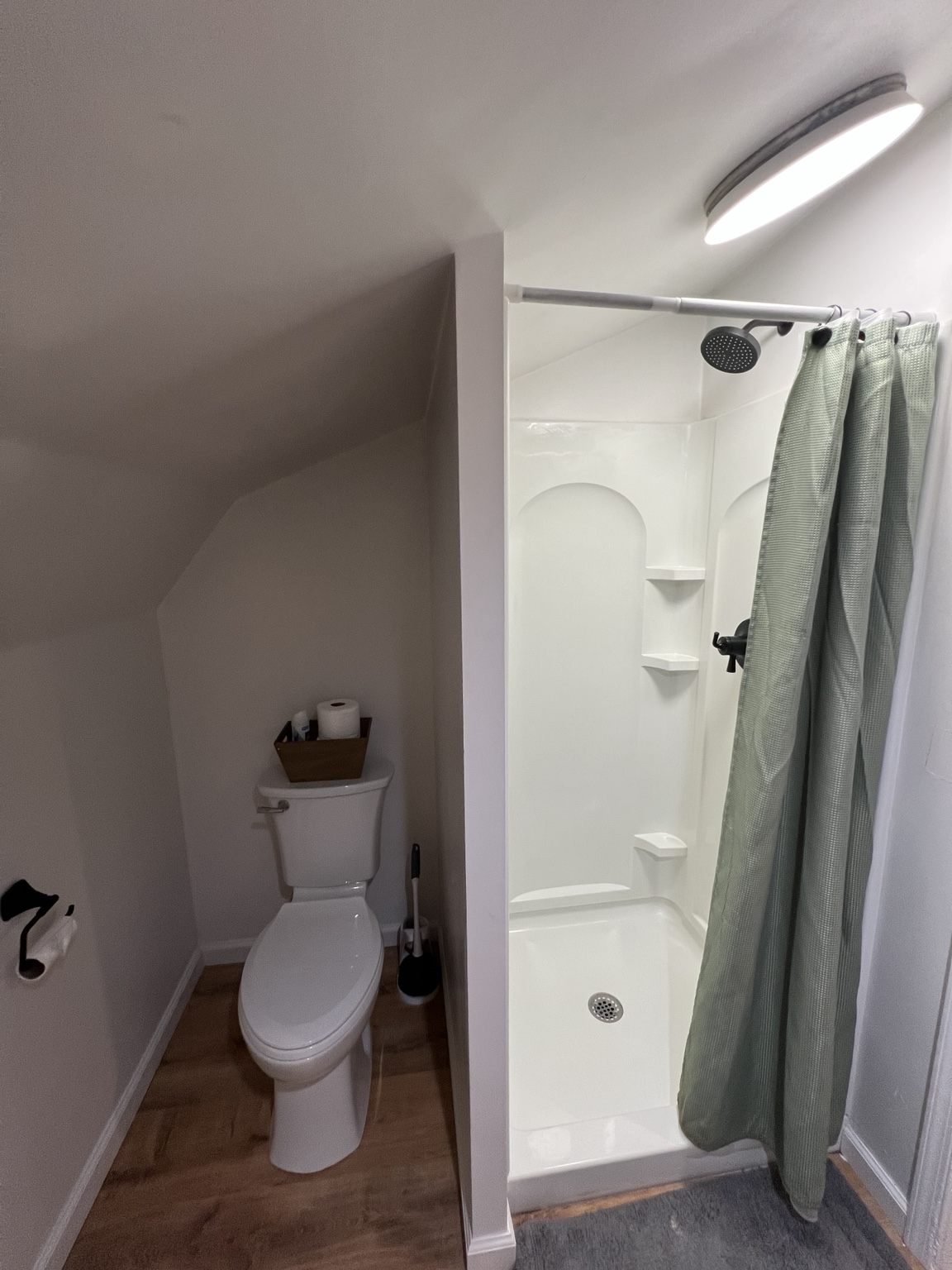 Bright walk-in shower tucked under the eaves